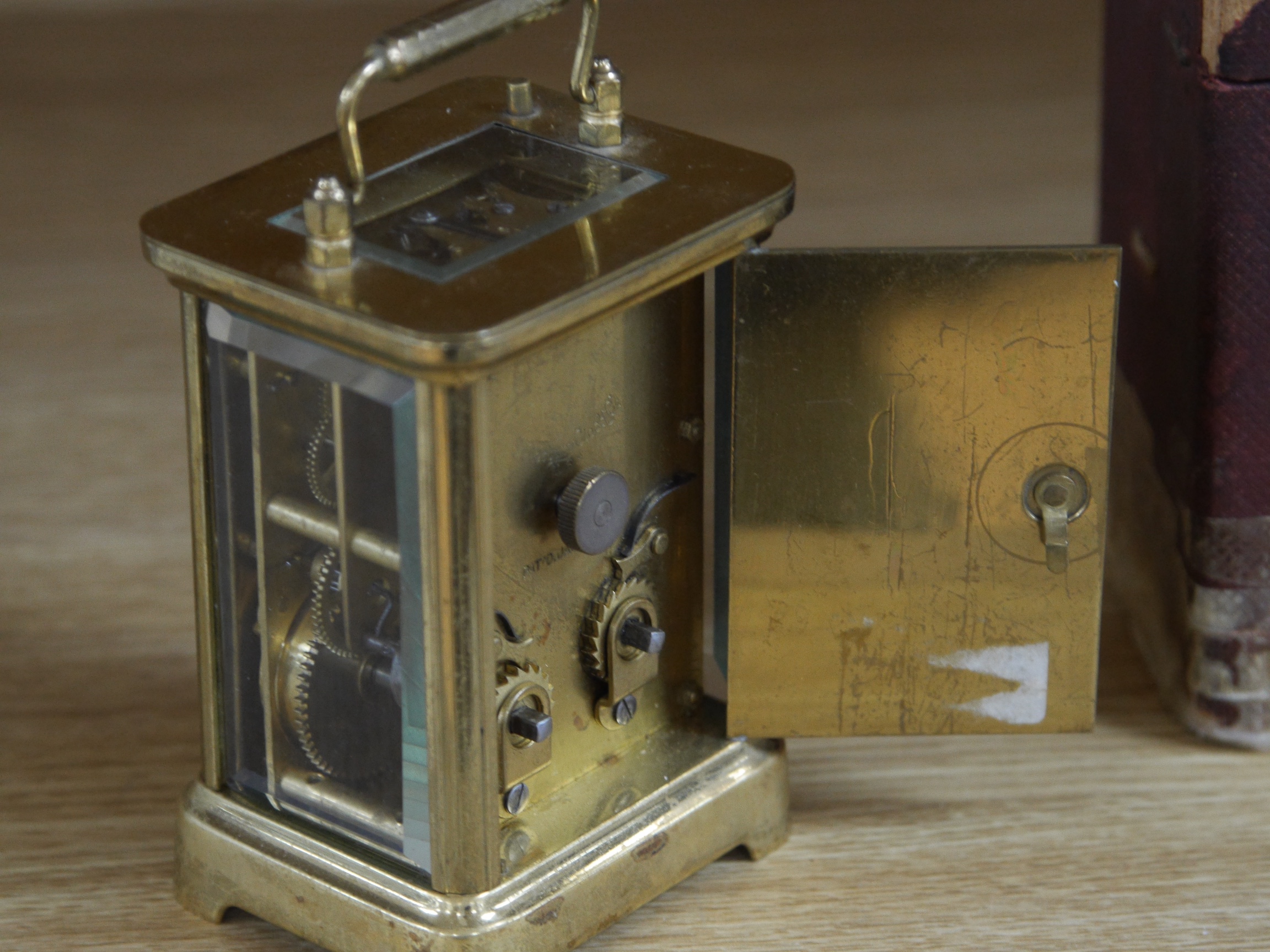 A cased carriage clock, 12cm high including handle. Condition - cased taped at base, clock unknown if it works.